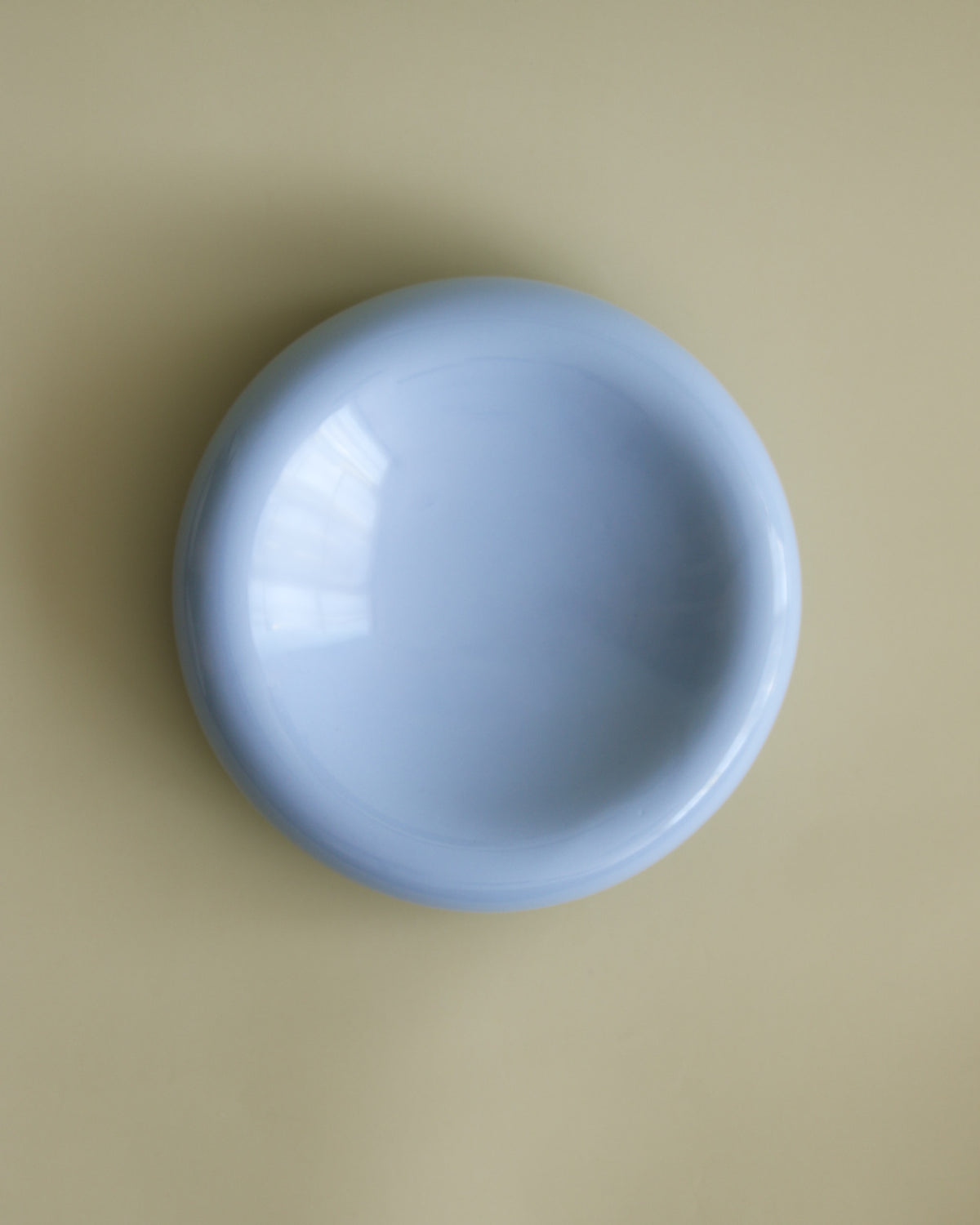 Top view of rounded, whisker friendly cat bowl in blue by Noots Pets. 