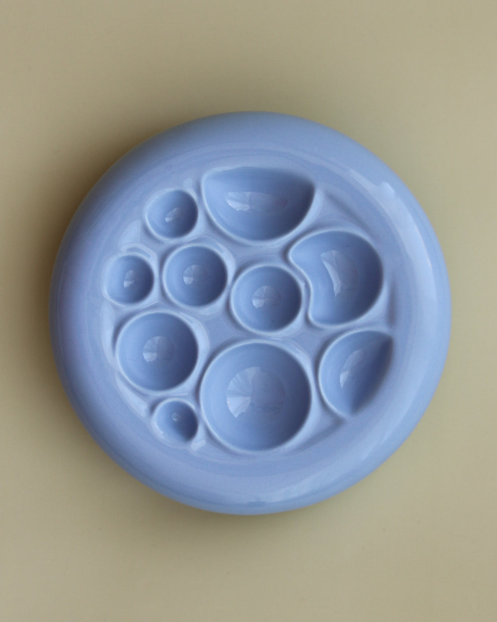 Noots Moonie ceramic slow feeder, crater-like design, top view.